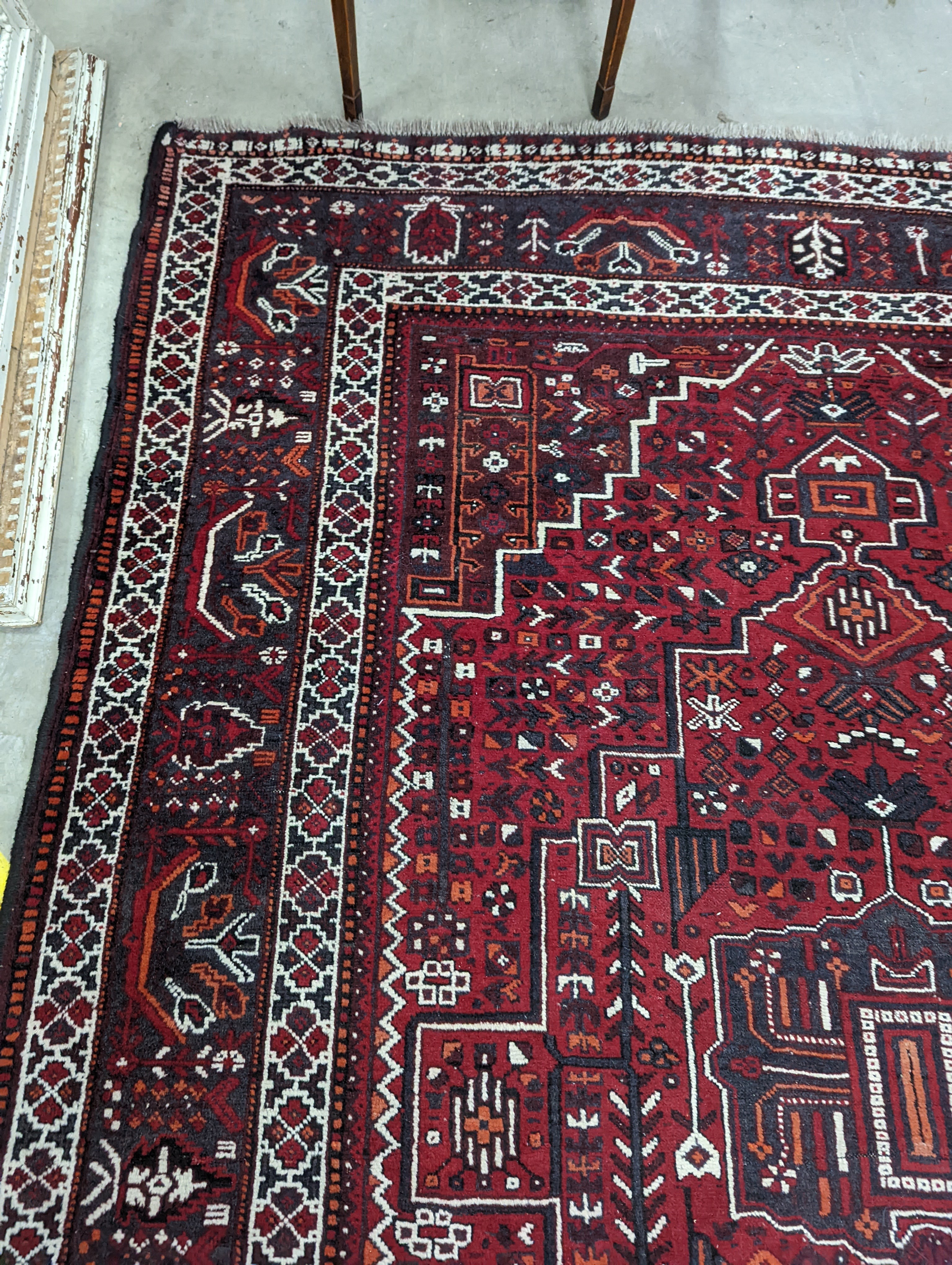 A Caucasian design burgundy ground carpet, 280 x 210cm